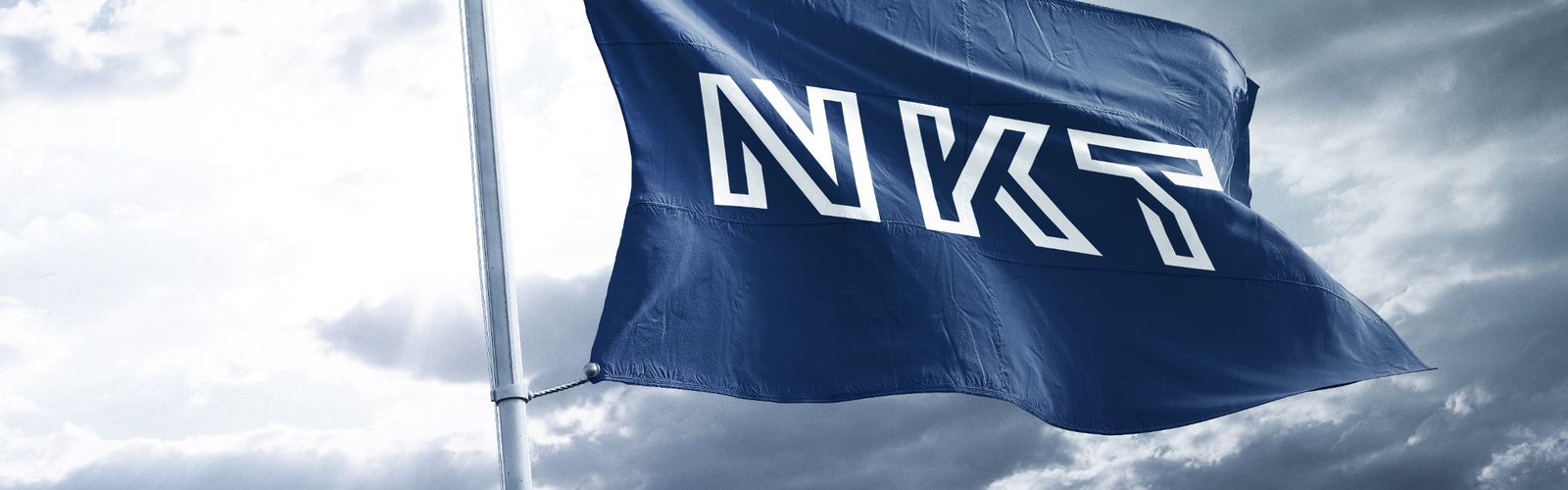 NKT flaf flying in the wind with grey sky